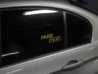 Fake taxi šviečiantis lipdukas